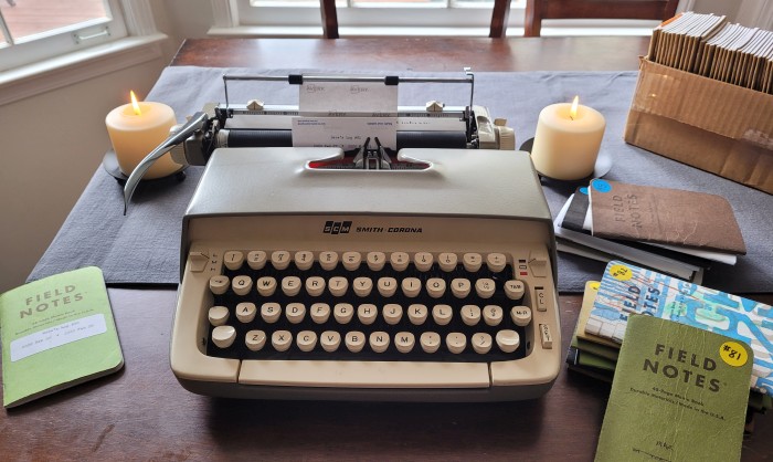 typewriter with labels for notebooks and candles