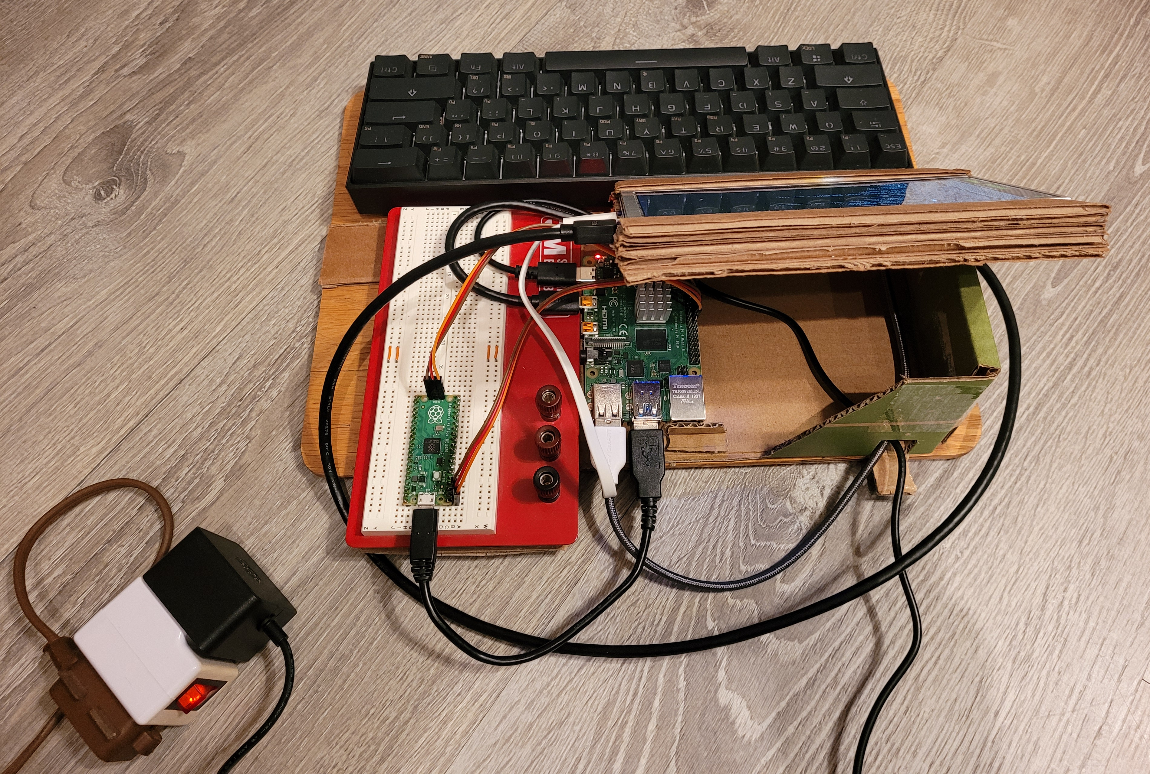 back view of current pi cardboard luggable station showing pi 4 computer and silly power switch for pi usb power transformer