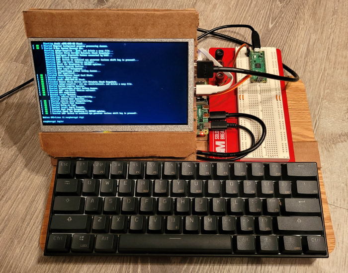 front view of current pi cardboard luggable station with breadboard on right and screen on left